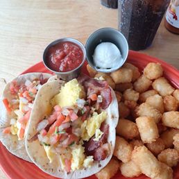 The gringo tacos-scrambled eggs,bacon,pico de gallo,sour cream and tater tots with 2 flour tortillas ,tater tots and salsa