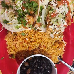 Taco plate: tempura shrimp taco and beer battered cod taco with a side of rice and beans