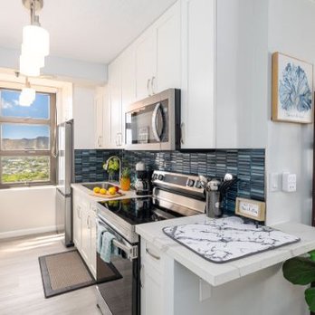 Liu Trading - a kitchen with white cabinets and black appliances - Countertop Installation Near Me - Honolulu, Hawaii Liu Trading - a kitchen with white cabinets and black appliances - Countertop Installation Near Me - Honolulu, Hawaii