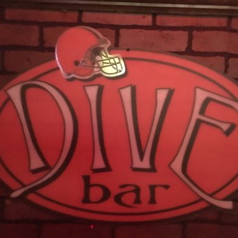 Dive Bar - a football helmet on top of a dive bar sign - Dive Bars Near Me - Cleveland, Ohio