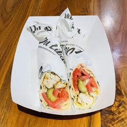 Cafe Du Liban - Grilled Chicken, Tomatoes, Pickles, Garlic Sauce wrapped in Pita Bread.