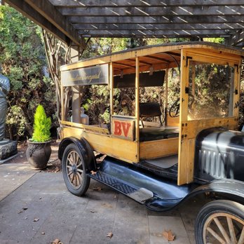 Beaulieu Vineyard - an antique car parked in front of a statue - Wineries Near Me - Rutherford, California