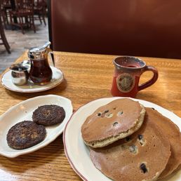 Buckwheat pancakes with blueberries and a side of sausage. Buckwheat pancakes with blueberries and a side of sausage.