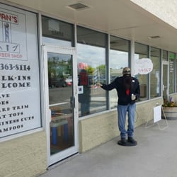 Ivan's Barber Shop - Ivan has stepped outside to greet people as they come into the barber shop