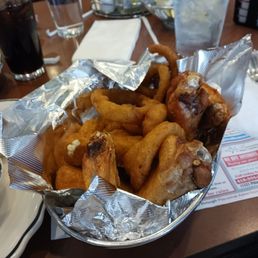 Basket of unseasoned chicken wings, mozzarella sticks, and onion rings. Basket of unseasoned chicken wings, mozzarella sticks, and onion rings.