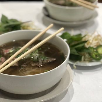 Pho Thang Cafe - a bowl of soup with chopsticks - Vietnamese Near Me - Cleveland, Ohio