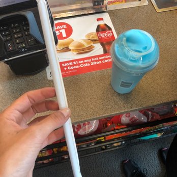 Circle K - a person using a cell phone at a counter - Convenience Stores Near Me - Fairfield, California