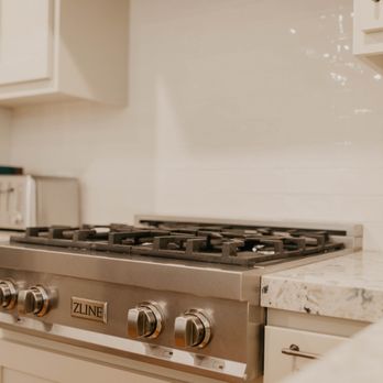 Apex Construction Innovations - kitchen with white cabinets and stainless steel appliances - General Contractors Near Me Apex Construction Innovations - kitchen with white cabinets and stainless steel appliances - General Contractors Near Me