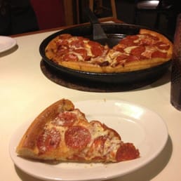 two slices of pepperoni pizza on a plate two slices of pepperoni pizza on a plate