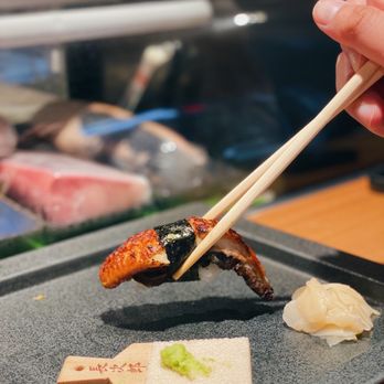 Yugafu Japanese Bistro - a person holding chopsticks over a plate of sushi - Japanese Near Me - Surrey, British Columbia Yugafu Japanese Bistro - a person holding chopsticks over a plate of sushi - Japanese Near Me - Surrey, British Columbia