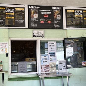 Paradise Grinds & Catering - Above you have the menu. They recently are open for dinner. The window in the middle is where you pay and pick up your plate/box lunches. - American Near Me - Līhue, Hawaii