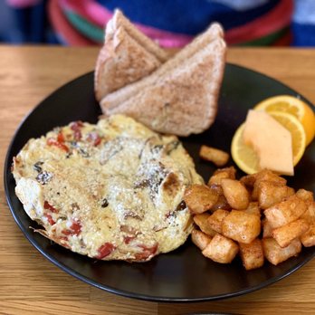 Tiramisu Bistro - The new Roasted Vegetable Omelette with goat cheese and multigrain toast. Comes with maple spiced potatoes & fresh fruit - Italian Near Me - Edmonton, Alberta Tiramisu Bistro - The new Roasted Vegetable Omelette with goat cheese and multigrain toast. Comes with maple spiced potatoes & fresh fruit - Italian Near Me - Edmonton, Alberta