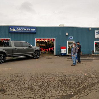 Albany Tire & Wheel - Customer checking out his new Moto Metal wheels wrapped with Cooper AT3 XLT tires. - Tires Near Me - Albany, Oregon Albany Tire & Wheel - Customer checking out his new Moto Metal wheels wrapped with Cooper AT3 XLT tires. - Tires Near Me - Albany, Oregon