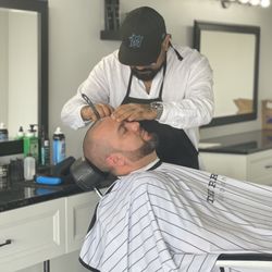 The Parlor Barbershop - Barber Erick giving a shave