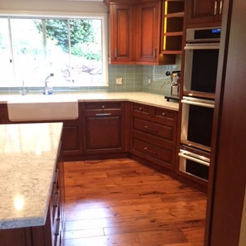 Modern Floors & Interiors - a kitchen with wood cabinets and a marble countertop - Carpeting Near Me - Solvang, California Modern Floors & Interiors - a kitchen with wood cabinets and a marble countertop - Carpeting Near Me - Solvang, California
