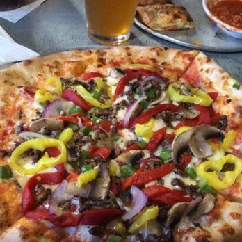 Millstone Pizza Tap House - Red sauce base, mozzarella, provolone, shaved ribeye, green peppers, red peppers, red onions, mushrooms, and banana peppers - Pizza Near Me - Rock Hill, South Carolina