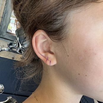 454 Tattoo and Body Piercing - Mapping her ear with a marker to make sure the second piercing is in alignment with her ear fold and first piercing. Really impressive. - Tattoo Near Me - Encinitas, California