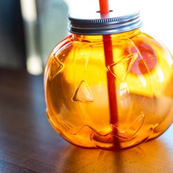 Oo de Lally Coffee - A plastic mug in the shape of a jack o lantern