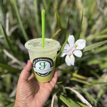 Grassroots Natural Market - a hand holding a green smoothie - Grocery Near Me - Jacksonville, Florida Grassroots Natural Market - a hand holding a green smoothie - Grocery Near Me - Jacksonville, Florida