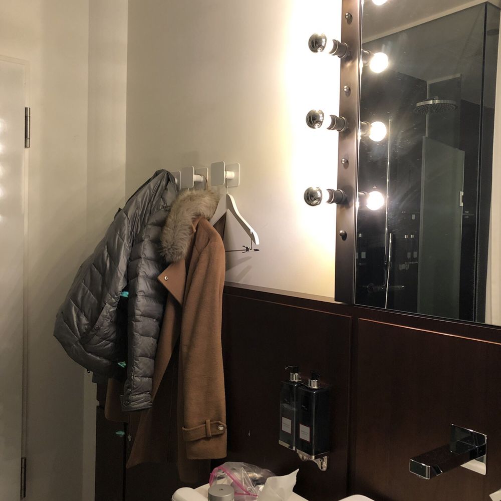 Hangers next to the front door on one side, next to the sink on the other side