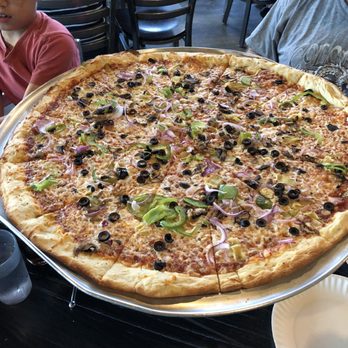 Slice Parlor - Huge veggie supreme pizza.  It takes up the whole table. - Pizza Near Me - Albuquerque, New Mexico