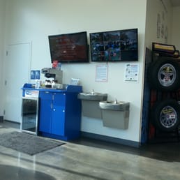 Waiting room with television to watch and another with camera views of the shop to watch your car being worked on.