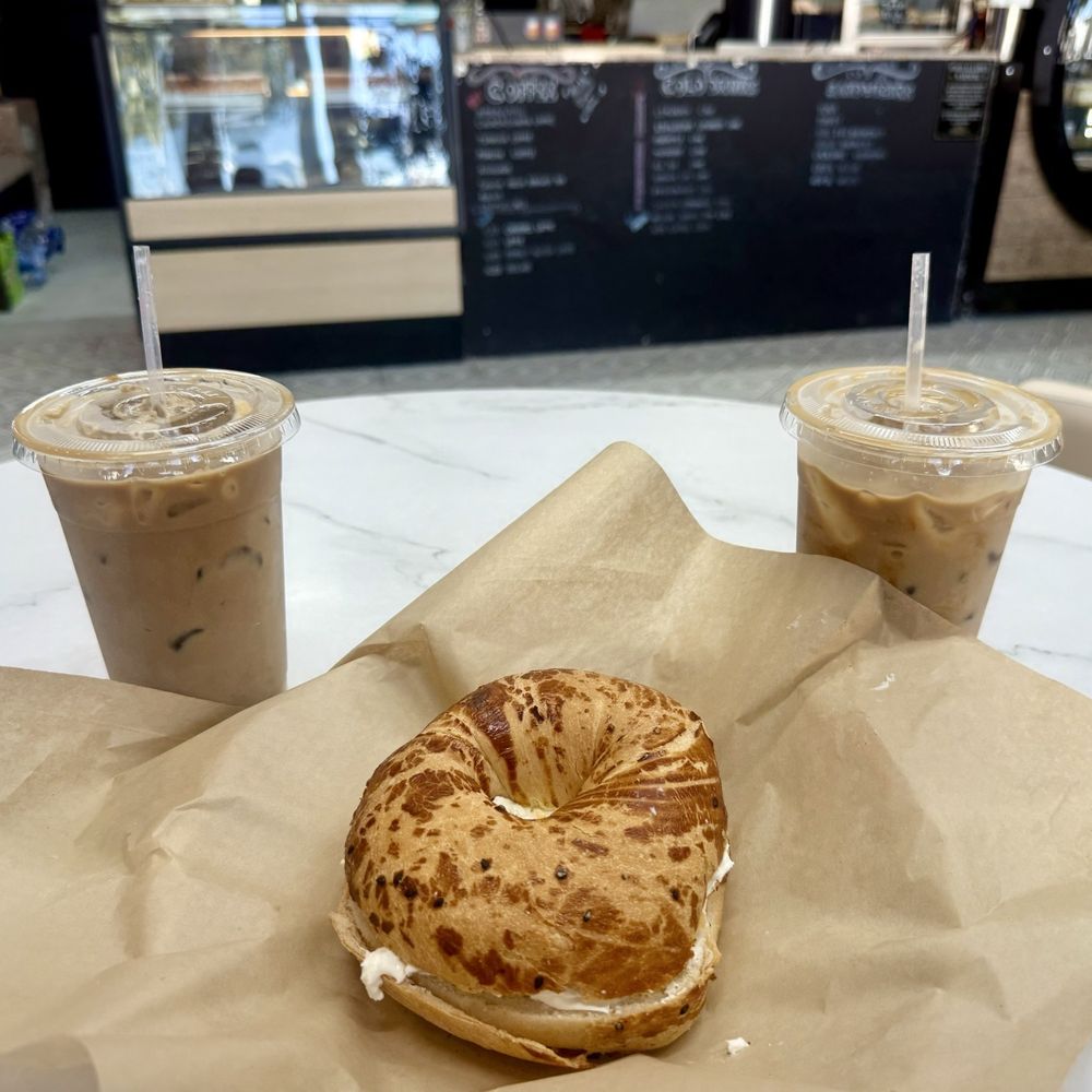 Hop In Bakery - Banana Latte on the left, Turkish bagel with cream cheese center, and Peanut Butter Latte on the right. - Sandwiches Near Me - Ocean City, Maryland Hop In Bakery - Banana Latte on the left, Turkish bagel with cream cheese center, and Peanut Butter Latte on the right. - Sandwiches Near Me - Ocean City, Maryland