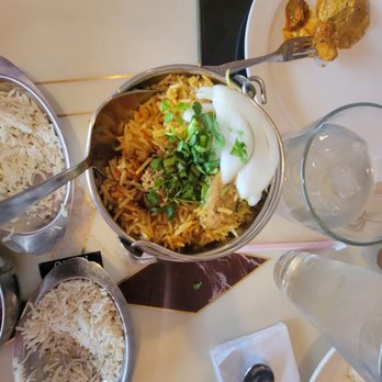 India Hut - a bowl of rice and other dishes on a table - Indian Near Me - El Paso, Texas