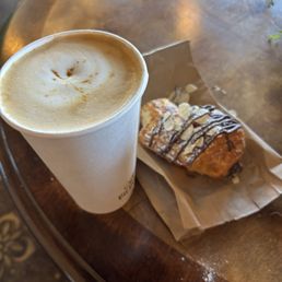 Oatmilk latte and almond chocolate croissant