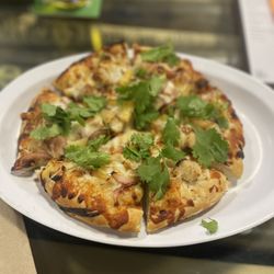 Stadium Pizza - Mini Thai Chicken Pizza flavorful Thai peanut sauce, chicken, crispy cashews, fresh mozzarella cheese, red onions, pineapple and cilantro.