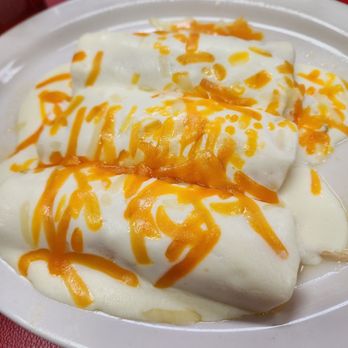 Chelino's Mexican Restaurant - Chicken enchilada with sour cream sauce from top - Mexican Near Me - Oklahoma City, Oklahoma Chelino's Mexican Restaurant - Chicken enchilada with sour cream sauce from top - Mexican Near Me - Oklahoma City, Oklahoma