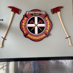 a fireman's badge and axes a fireman's badge and axes