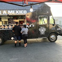 Exterior outside entrance of Tacos Gutierrez - Side view of taco truck with slogan - Santa Ana, California Exterior outside entrance of Tacos Gutierrez - Side view of taco truck with slogan - Santa Ana, California