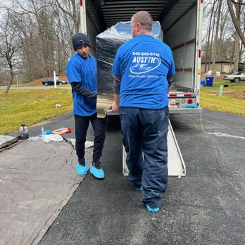 Austin Services - two men unloading a moving truck - Movers Near Me