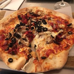 a pizza on a cutting board a pizza on a cutting board