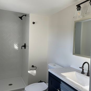 DoConstruction - a bathroom with a toilet, sink, and shower - Flooring Near Me