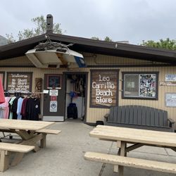 Leo Carrillo Beach Store - Picnic tables with umbrellas, outside seating, large chair for photos