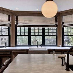 Tyler & Sash - A touch of sophistication with these beautiful roman shades accented with black tape detail.