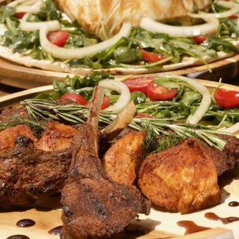 Black Iris - two plates of food on a wooden table - Mediterranean Near Me - Brooklyn, New York