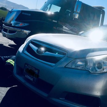 Mikes Towing - Driver removing damaged splash shield - Towing Near Me Mikes Towing - Driver removing damaged splash shield - Towing Near Me