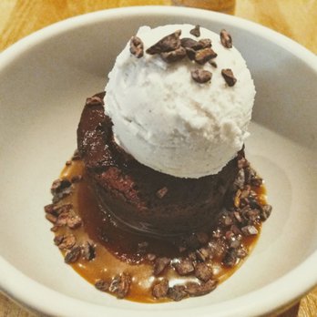 True Food Kitchen - Flourless Chocolate Cake - Caramel, almond, vanilla ice cream, and cacao nib. - New American Near Me - Chicago, Illinois True Food Kitchen - Flourless Chocolate Cake - Caramel, almond, vanilla ice cream, and cacao nib. - New American Near Me - Chicago, Illinois