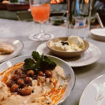 Homer - Hummus with chickpeas and cumin, with a side of whipped garlic. - Mediterranean Near Me - Seattle, Washington Homer - Hummus with chickpeas and cumin, with a side of whipped garlic. - Mediterranean Near Me - Seattle, Washington