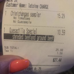 a person's hand holding a receipt