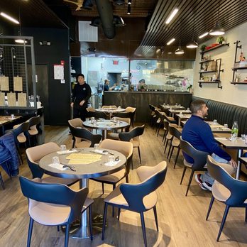 Sum Ramen - a man sitting at a table in a restaurant - Ramen Near Me - Westfield, New Jersey