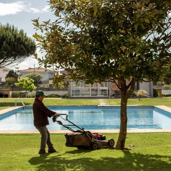 Western Yard & Maintenance - a man mowing the lawn - Landscaping Near Me