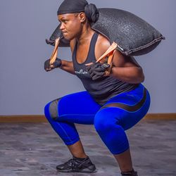Nshape Fitness for Her - 50 year old women squatting a 50 lbs wreck bag