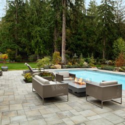Alderwood Landscaping Architecture Construction - Poolside pavers with a fire pit table and seating area.
