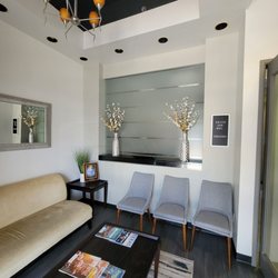 Dental Professionals Of Spring - This is a very artsy and modern waiting area. The office overall shares similar vibes. Very clean and contemporary styling.
