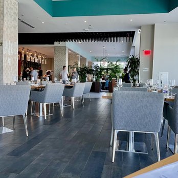 Julian Restaurant - Cozy yet open air dining area looking into an adjacent bar. - Tapas/Small Plates Near Me - Tampa, Florida Julian Restaurant - Cozy yet open air dining area looking into an adjacent bar. - Tapas/Small Plates Near Me - Tampa, Florida