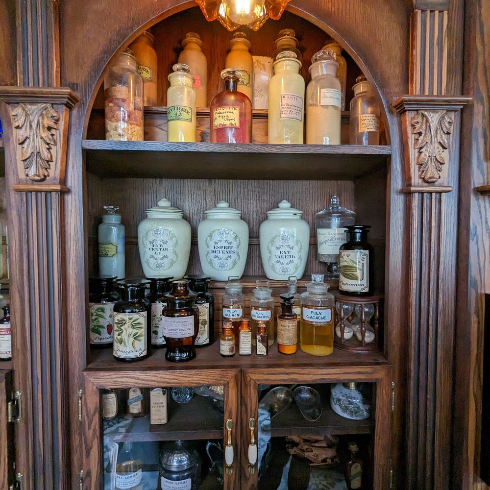Prequel & Co. Apothecary - a shelf with bottles and jars - Cocktail Bars Near Me - Toronto, Ontario